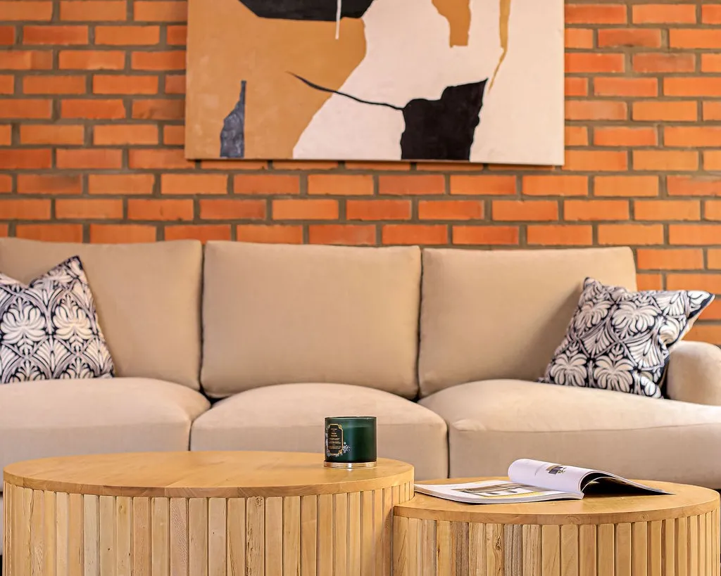 Two round slatted coffee tables in front of a sofa