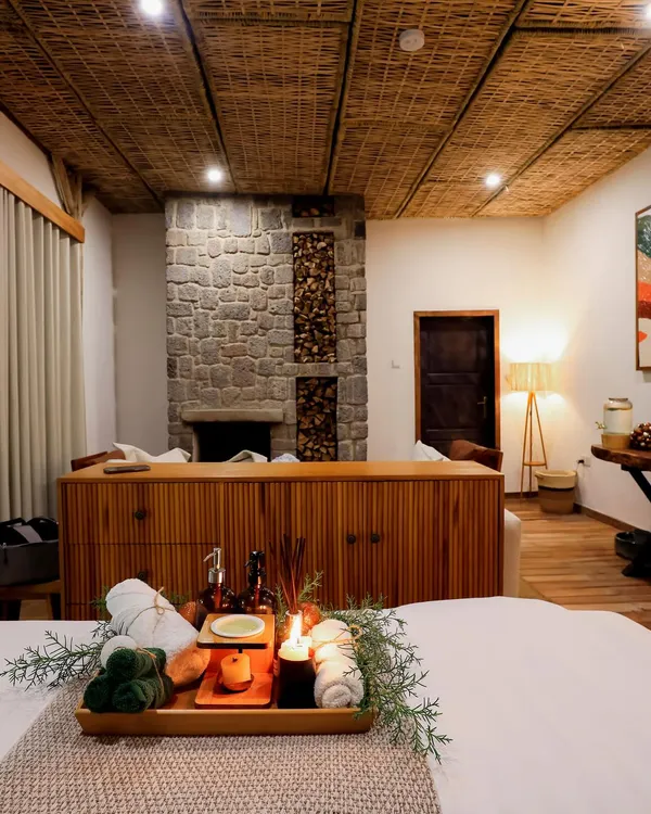 Spa suite with a fluted sideboard in front of a stone fireplace