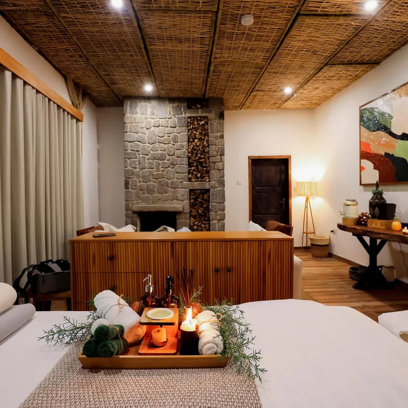 Spa suite with a fluted sideboard in front of a stone fireplace