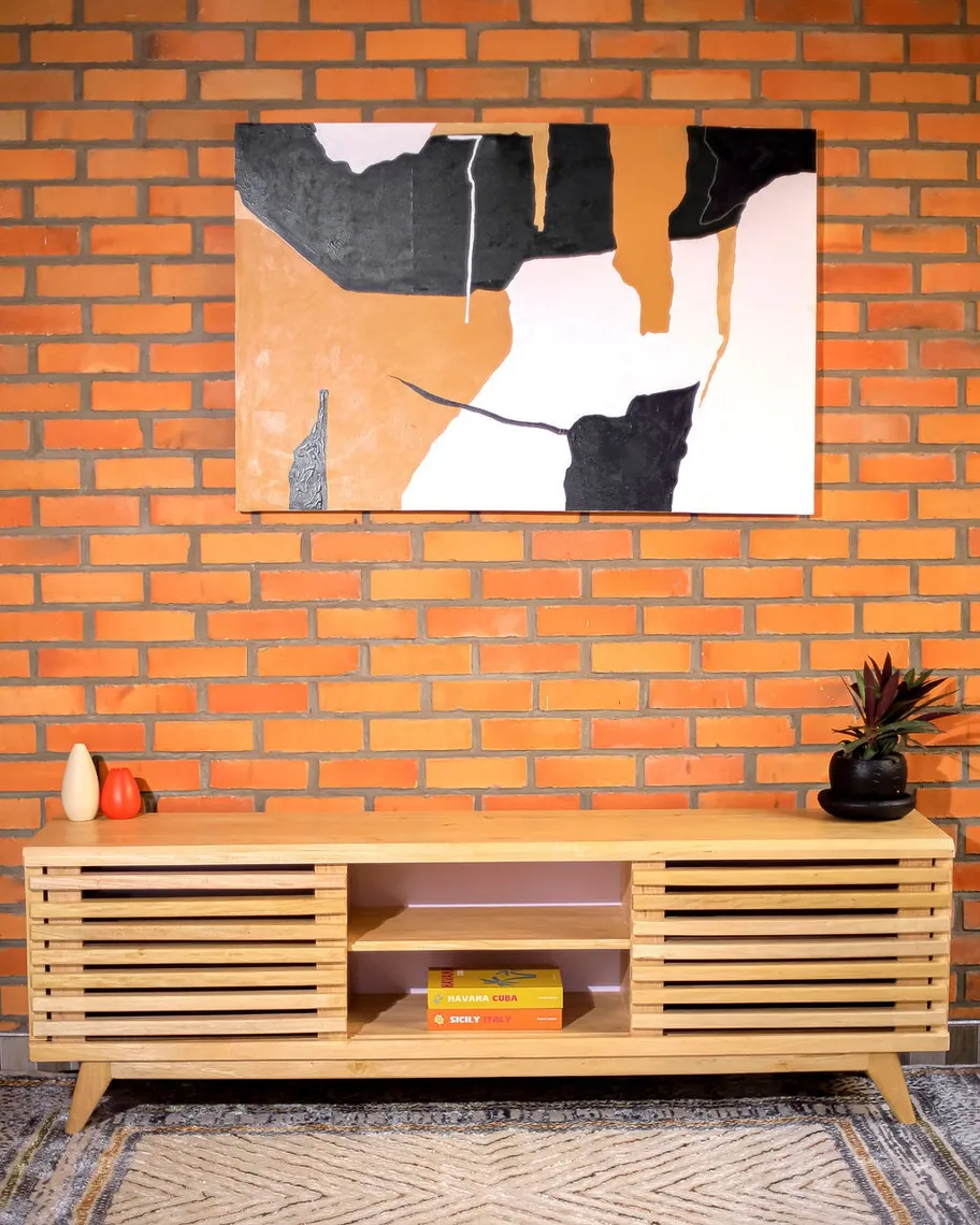 Slatted wooden sideboard beneath an abstract painting